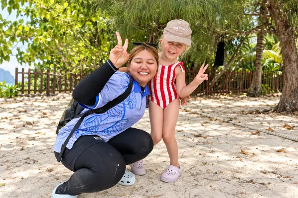 Krabi Bliss trip guide posing with a young guest on the beach