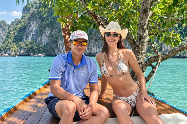 Krabi Bliss trip guide sitting with a guest on the bow of the longtail boat